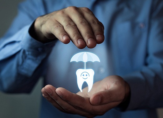 Man holding animated tooth under an umbrella